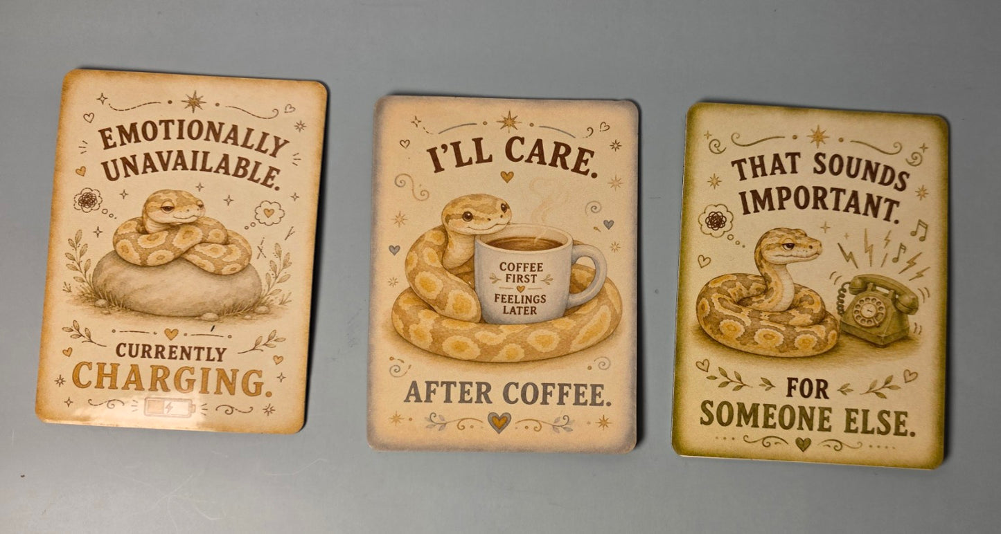 Three decorative snake-themed magnets with snake illustrations and humorous text on a gray background