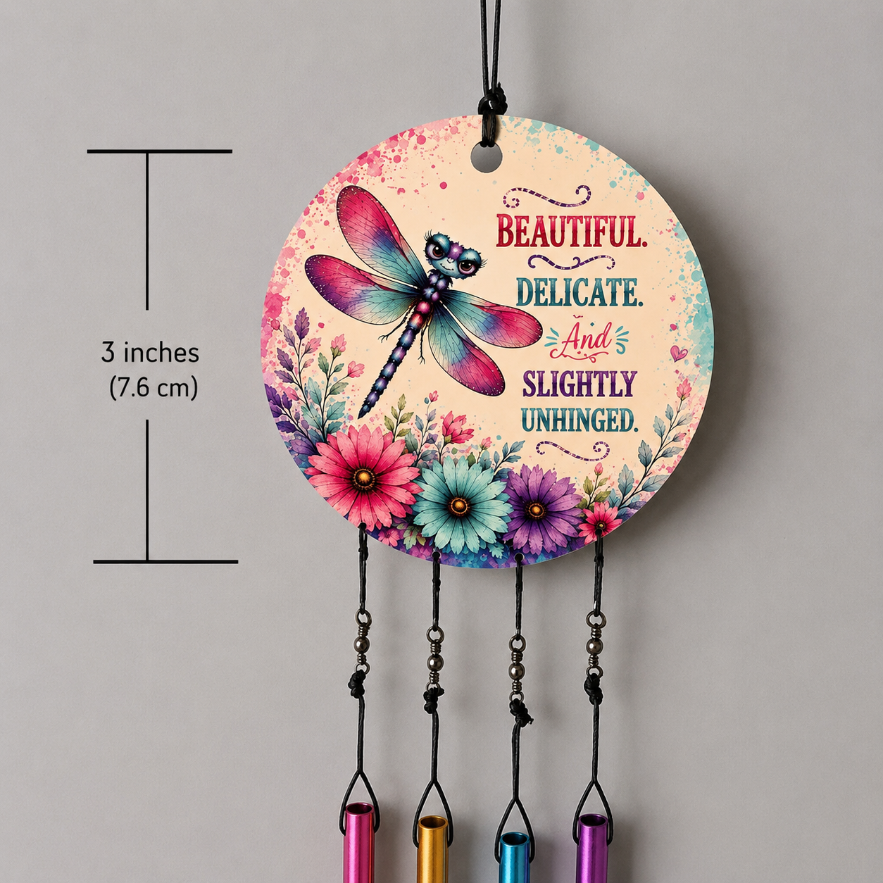 Decorative hanging ornament with dragonfly and floral design, featuring text and measurements.