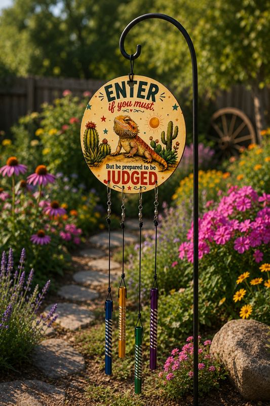 Decorative garden sign with a lizard and cactus design, surrounded by flowers and a wooden cart in the background.