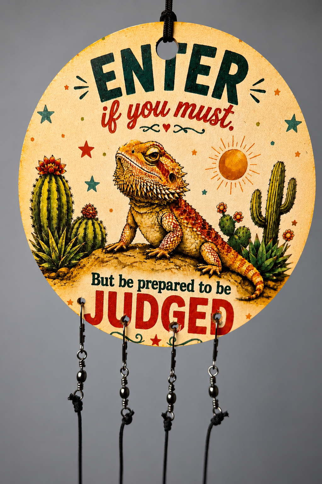 Decorative sign with a bearded dragon and cacti design, featuring text on a gray background.