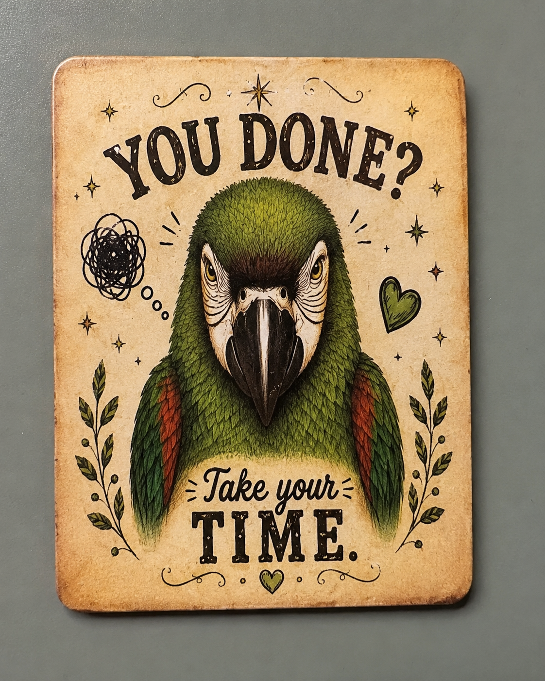 A rectangular vintage-style wall sign with rounded corners featuring an illustration of a green parrot and the text 'YOU DONE? Take your TIME.' on a warm beige background, shown against a dark gray wall.