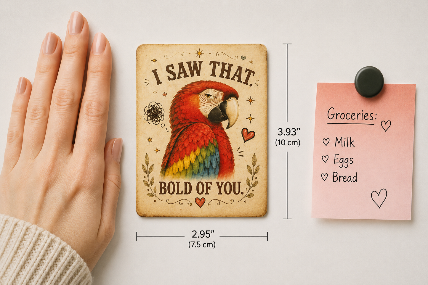 A square decorative coaster or print featuring a colorful parrot and the text 'I SAW THAT BOLD OF YOU.' is shown next to a pink sticky note on a white background, with a hand on the left and dimension lines indicating 3.