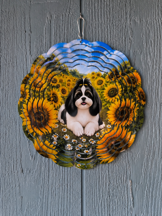 A scalloped metal garden sign featuring a black and white Shih Tzu dog sitting in a field of yellow sunflowers under a blue sky, hanging on a gray wood-textured surface.