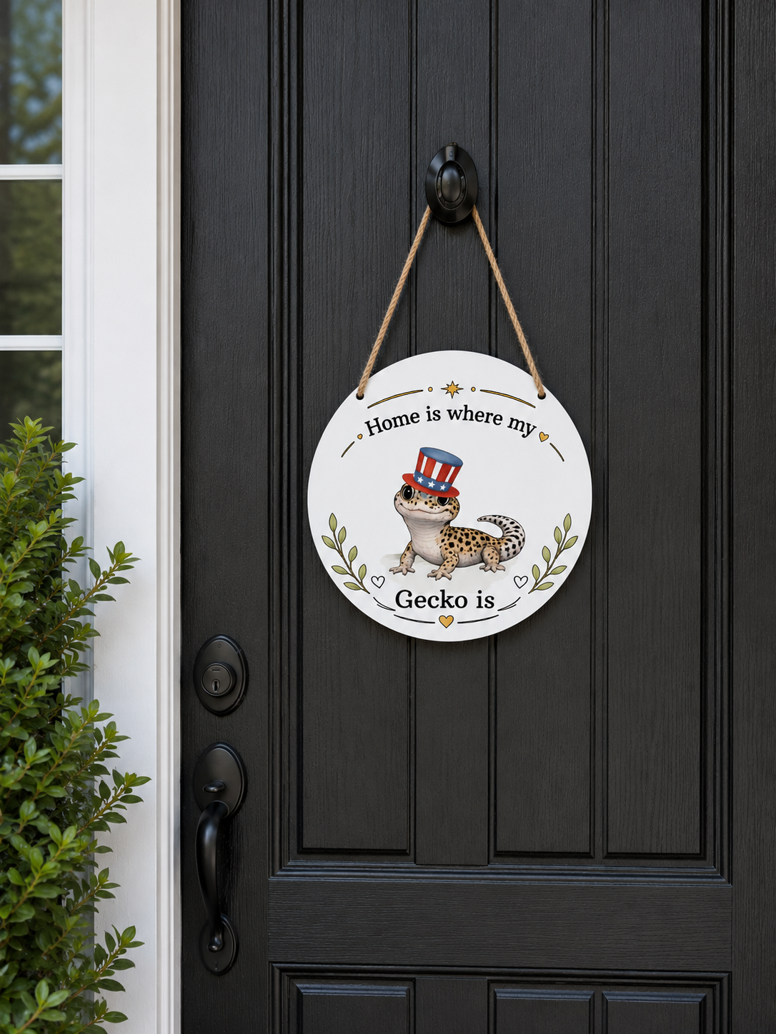 Decorative sign with a gecko illustration on a black door