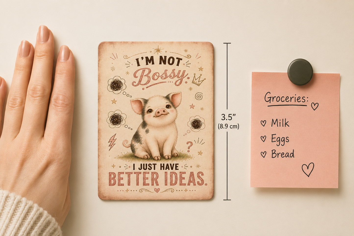 mini pig-themed magnets illustration and text, next to a pink notepad with a magnet.