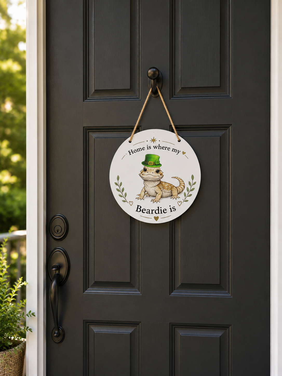 Decorative sign with a bearded dragon illustration on a black door.