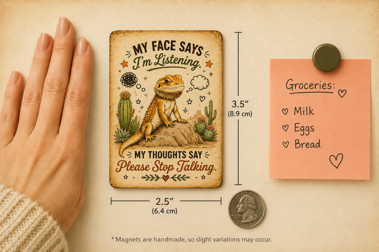 Small magnet with a bearded dragon design and text, next to a hand for scale, a coin for size reference, and a pink notepad with groceries list.
