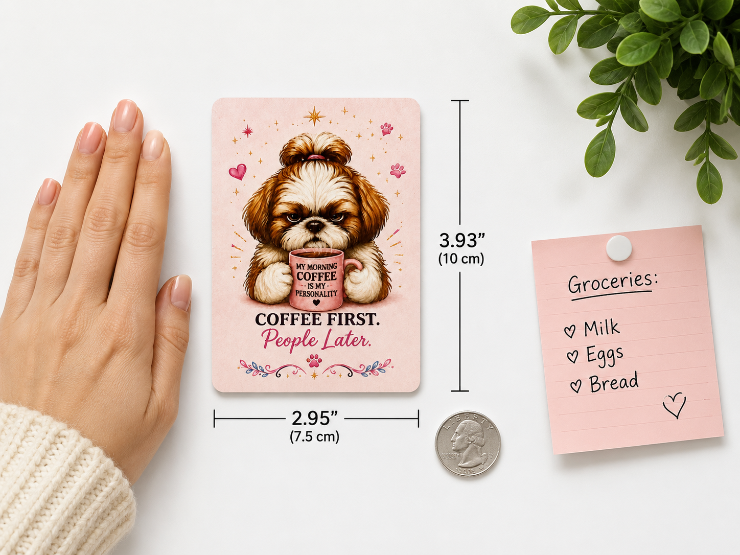 Small pink notepad with a Shih Tzu illustration and text, held by a hand next to a coin for scale.