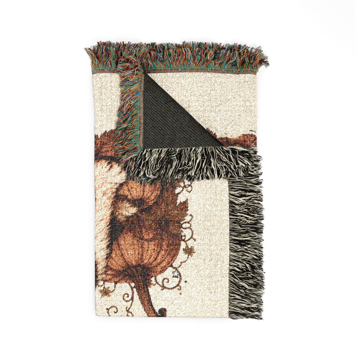 A rectangular woven throw blanket with fringe, featuring a botanical design with a brown leaf motif on a cream background and a black triangular section, shown flat on a white background.