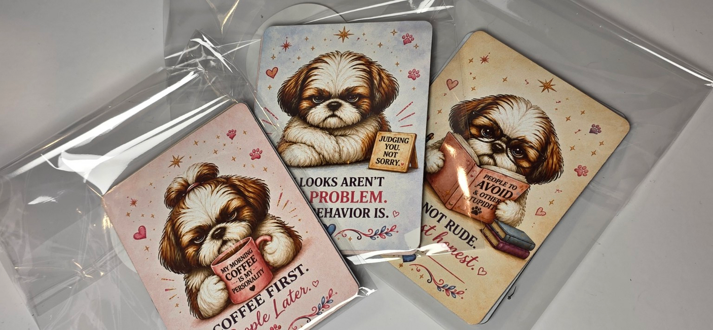 Three magnets with Shih Tzu dog illustrations and humorous text on a clear surface