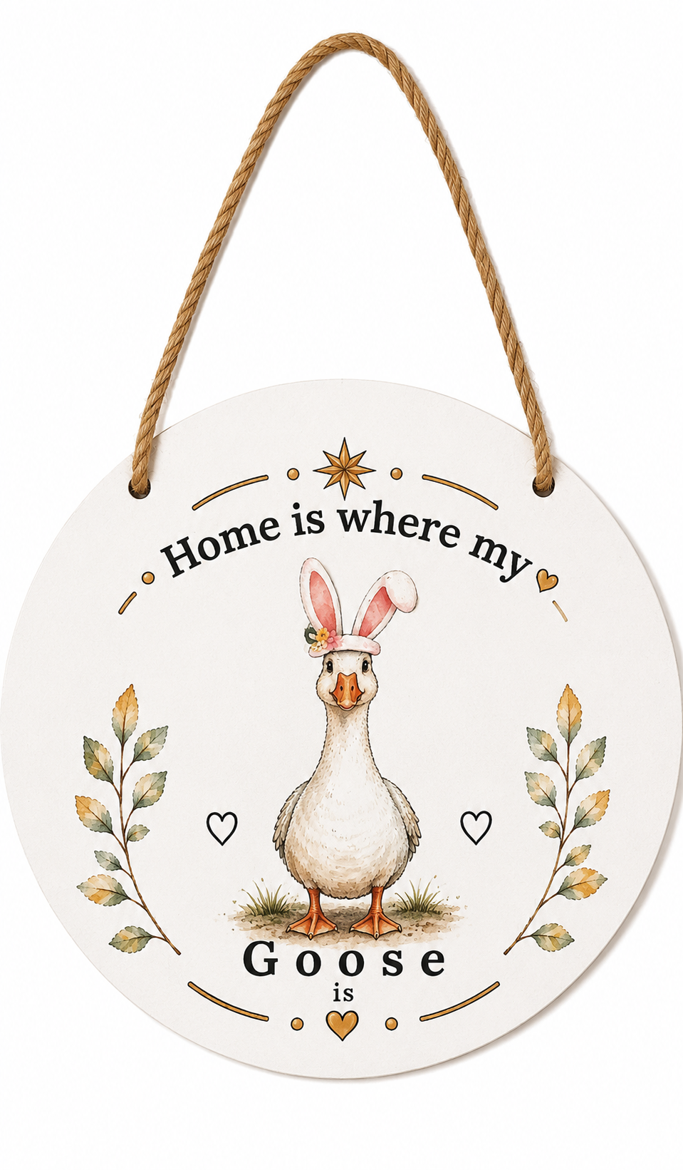 Round hanging wall sign with a rope hanger, featuring an illustrated white goose wearing bunny ears and the text 'Home is where my Goose is' with decorative leaves and hearts.