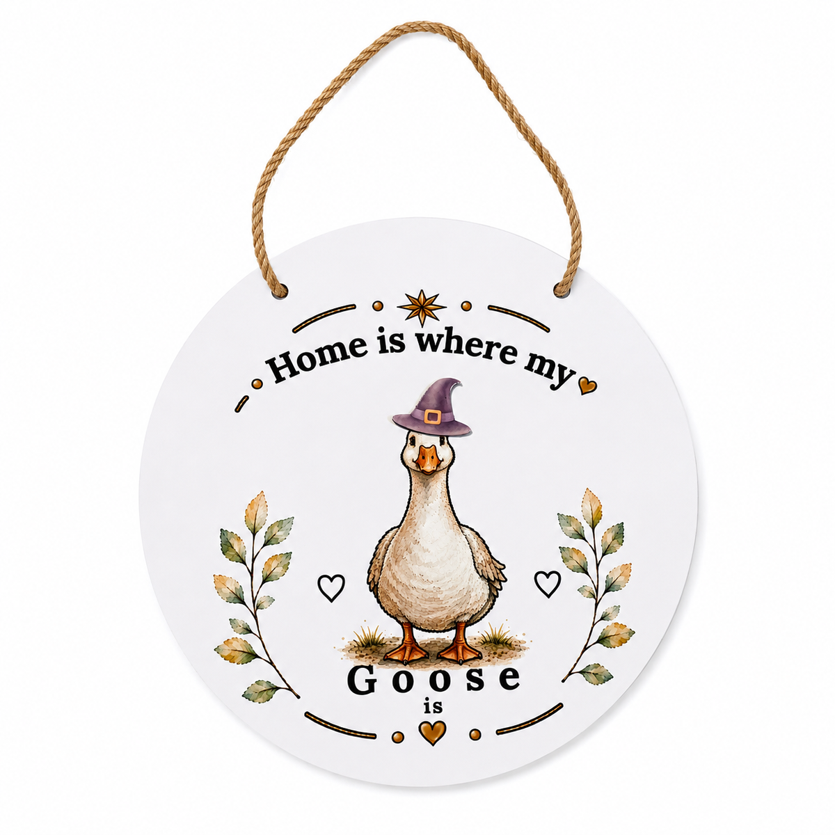 Round white hanging wall sign with a rope hanger, featuring an illustrated goose wearing a purple witch hat, with the text 'Home is where my Goose is' and small decorative leaves and hearts.